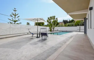 a patio with a hammock and a swimming pool at Amazing Home In Trabia in Trabia