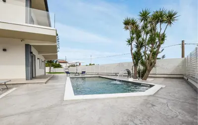 a pool with a water fountain in a yard at Amazing Home In Trabia in Trabia