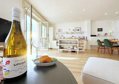 a bottle of wine on a table in a living room at Solemar Sicilia - Casa Sabine in Santa Flavia