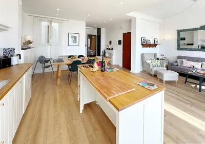 a kitchen and living room with a large counter top at Solemar Sicilia - Casa Sabine in Santa Flavia