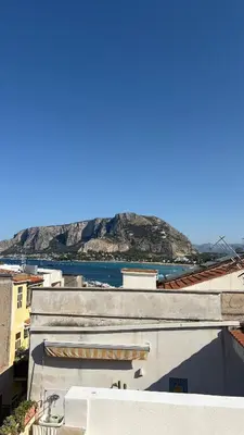 a view from the roof of a building with a mountain in the background at Ciàuru di mari Mondello apartment and terrace in Palermo
