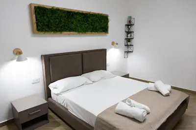 a bedroom with a bed with towels on it at Adagos in Palermo