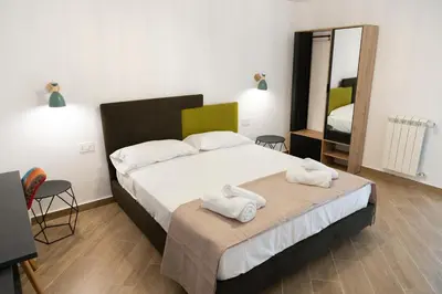 a bedroom with a bed with towels on it at Adagos in Palermo