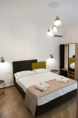 a bedroom with a bed with two towels on it at Adagos in Palermo