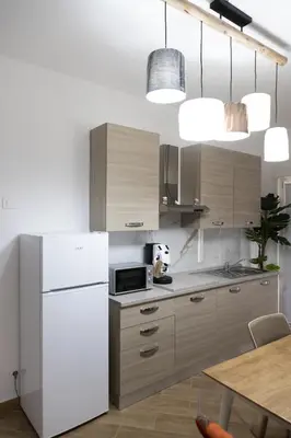 a kitchen with a white refrigerator and a table at Adagos in Palermo