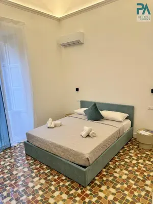 a bedroom with a bed with two towels on it at Palermo Central Rooms in Palermo