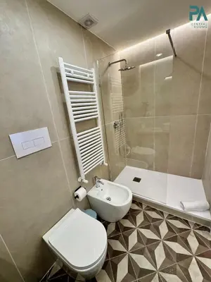 a bathroom with a toilet and a sink and a shower at Palermo Central Rooms in Palermo
