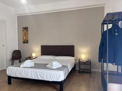 a bedroom with a bed with two towels on it at Casa Mama in Palermo