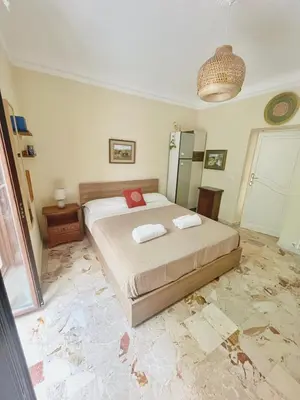 a bedroom with a large bed in a room at La Casa Nei Mondi in Palermo