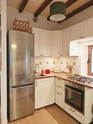 a kitchen with a stainless steel refrigerator and white cabinets at La Casa Nei Mondi in Palermo