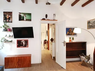 a living room with a flat screen tv on the wall at La Casa Nei Mondi in Palermo