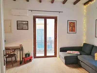a living room with a couch and a table at La Casa Nei Mondi in Palermo