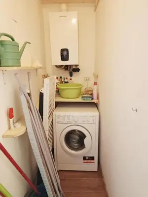 a kitchen with a washing machine in a room at La Casa Nei Mondi in Palermo