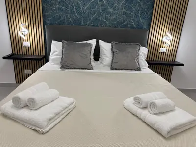 a bedroom with a large bed with towels on it at Sasi Home in Terrasini