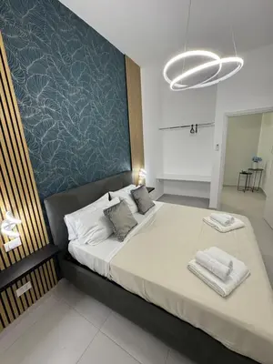 a bedroom with a large bed with towels on it at Sasi Home in Terrasini