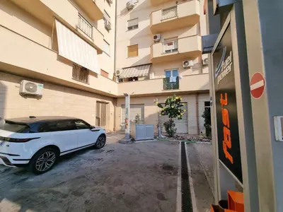a white car parked in front of a building at Sasi Home in Terrasini