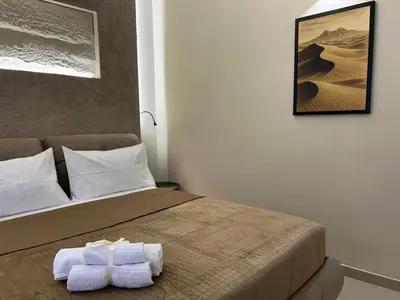 a bedroom with a bed with two towels on it at Vulpi 29 Apartment-Deluxe in Palermo