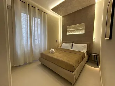 a bedroom with a bed and a large window at Vulpi 29 Apartment-Deluxe in Palermo