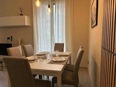 a dining room table with chairs and a table and a table and chairsktop at Vulpi 29 Apartment-Deluxe in Palermo