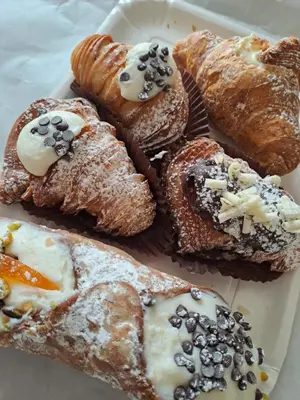 a white plate of pastries on a table at ANGELA Rooms in Marineo