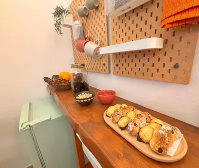 a table with a cutting board with pastries on it at Marie Claire Guest House in Palermo