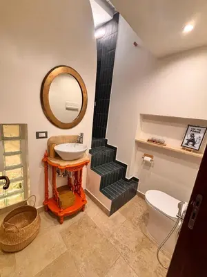 a bathroom with a sink and a toilet and a staircase at Marie Claire Guest House in Palermo
