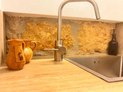 a kitchen counter with a sink and a faucet at Marie Claire Guest House in Palermo