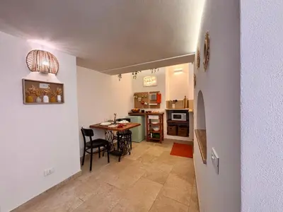 a kitchen and dining room with a table and chairs at Marie Claire Guest House in Palermo