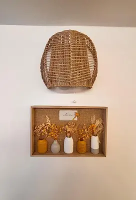 a shelf with three vases and a wicker basket at Marie Claire Guest House in Palermo