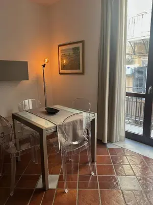 a dining room with a table and chairs and a window at Tinchitè - A due passi dal Teatro Massimo in Palermo
