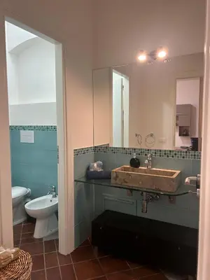 a bathroom with a sink and a toilet and a mirror at Tinchitè - A due passi dal Teatro Massimo in Palermo