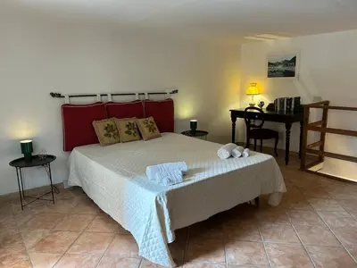 a bedroom with a large bed and a desk at Settebello - Antica Mangiatoia Palermitana in Palermo