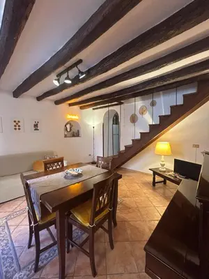 a dining room with a table and a staircase at Settebello - Antica Mangiatoia Palermitana in Palermo