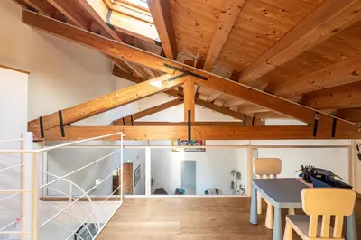 a room with wooden ceilings and a table and chairs at San Salvatore Apartment by Wonderful Italy in Palermo