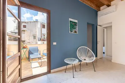a room with a blue wall and two chairs at San Salvatore Apartment by Wonderful Italy in Palermo