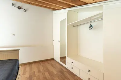 a bedroom with a bed and a closet at San Salvatore Apartment by Wonderful Italy in Palermo