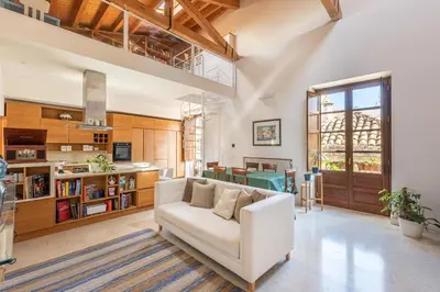 a living room with a couch and a book shelf at San Salvatore Apartment by Wonderful Italy in Palermo