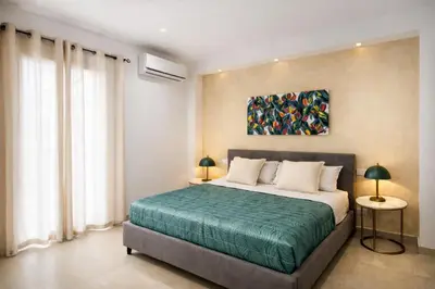 a bedroom with a bed and a painting on the wall at A' meusa Palermo Historic Center Check-in 24h in Palermo
