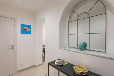 a hallway with a window and a black table at A' meusa Palermo Historic Center Check-in 24h in Palermo