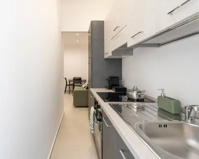 a kitchen with a sink and a stove at A' meusa Palermo Historic Center Check-in 24h in Palermo
