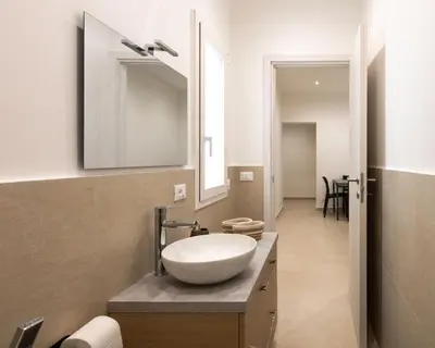 a bathroom with a sink and a mirror at A' meusa Palermo Historic Center Check-in 24h in Palermo