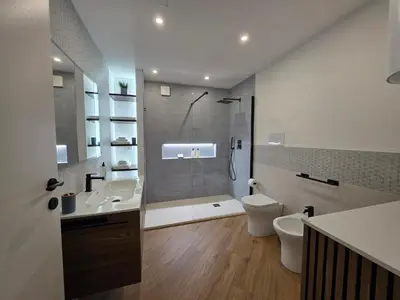 a bathroom with a sink and a mirror and a toilet at Marèa in Porticello