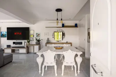a dining room with a white table and chairs at Elegant Villa With Pool Luxury in Carini