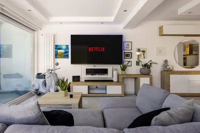 a living room with a couch and a tv at Elegant Villa With Pool Luxury in Carini