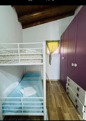 a hallway of a house with a door and a chair at Villa Liliana in San Giuseppe Jato