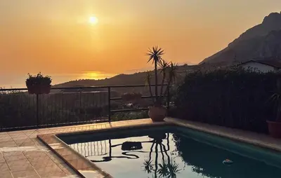 a swimming pool with a sunset in the background at Amazing Home In Caccamo in Caccamo