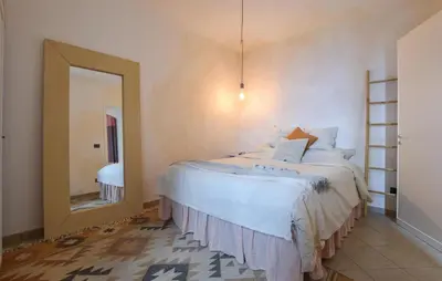 a bedroom with a large bed and a mirror at Amazing Home In Caccamo in Caccamo