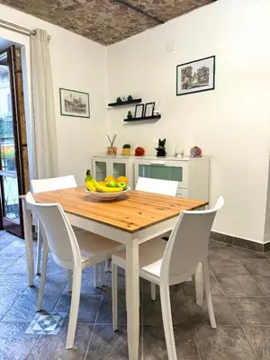 a dining room table with chairs and a bowl of fruit at Nel Cuore del Capo in Palermo