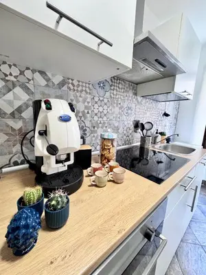 a kitchen counter with a coffee machine on a counter at Nel Cuore del Capo in Palermo