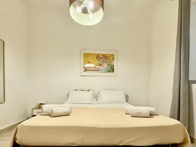 a bedroom with a large bed with a light at Dimora Sant'Agostino in Palermo